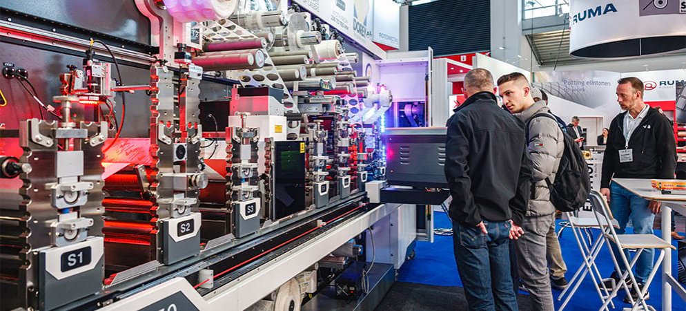 Exhibitors and visitors looking at a product at ICE Europe